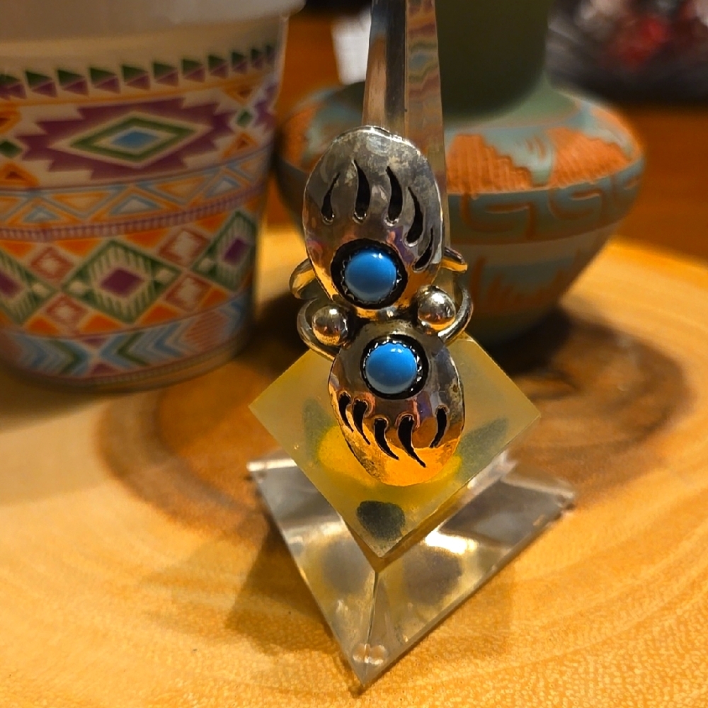 Sterling silver ring set in a double bear claw design.